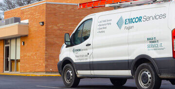 EMCOR Services Fagan work van parked at a clients facility